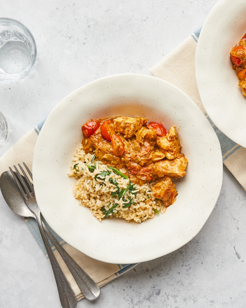 A hug in a bowl. Succulent free-range British chicken is simmered in creamy coconut yoghurt and vibrant red pesto. Serve over a bed of steaming brown rice and leafy spinach. It's a Mediterranean-inspired delight.