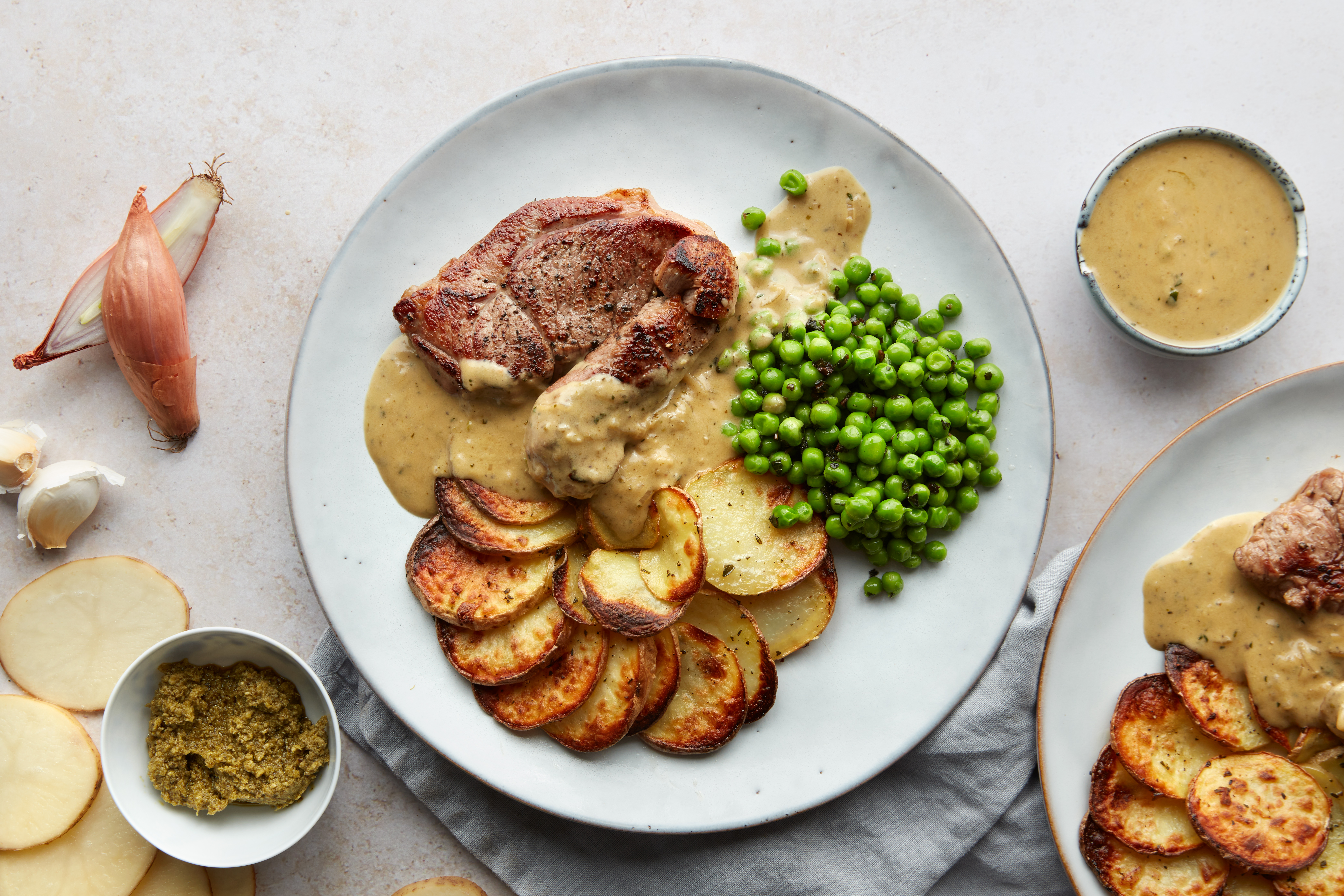 Lamb steak with minted peas, potato galette & pesto