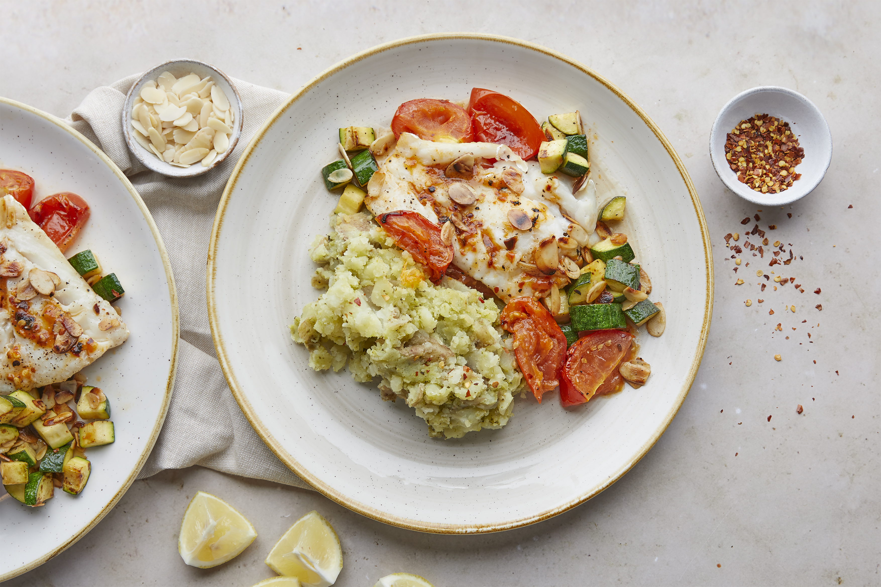 Hake with pesto mash & chilli roasted tomatoes