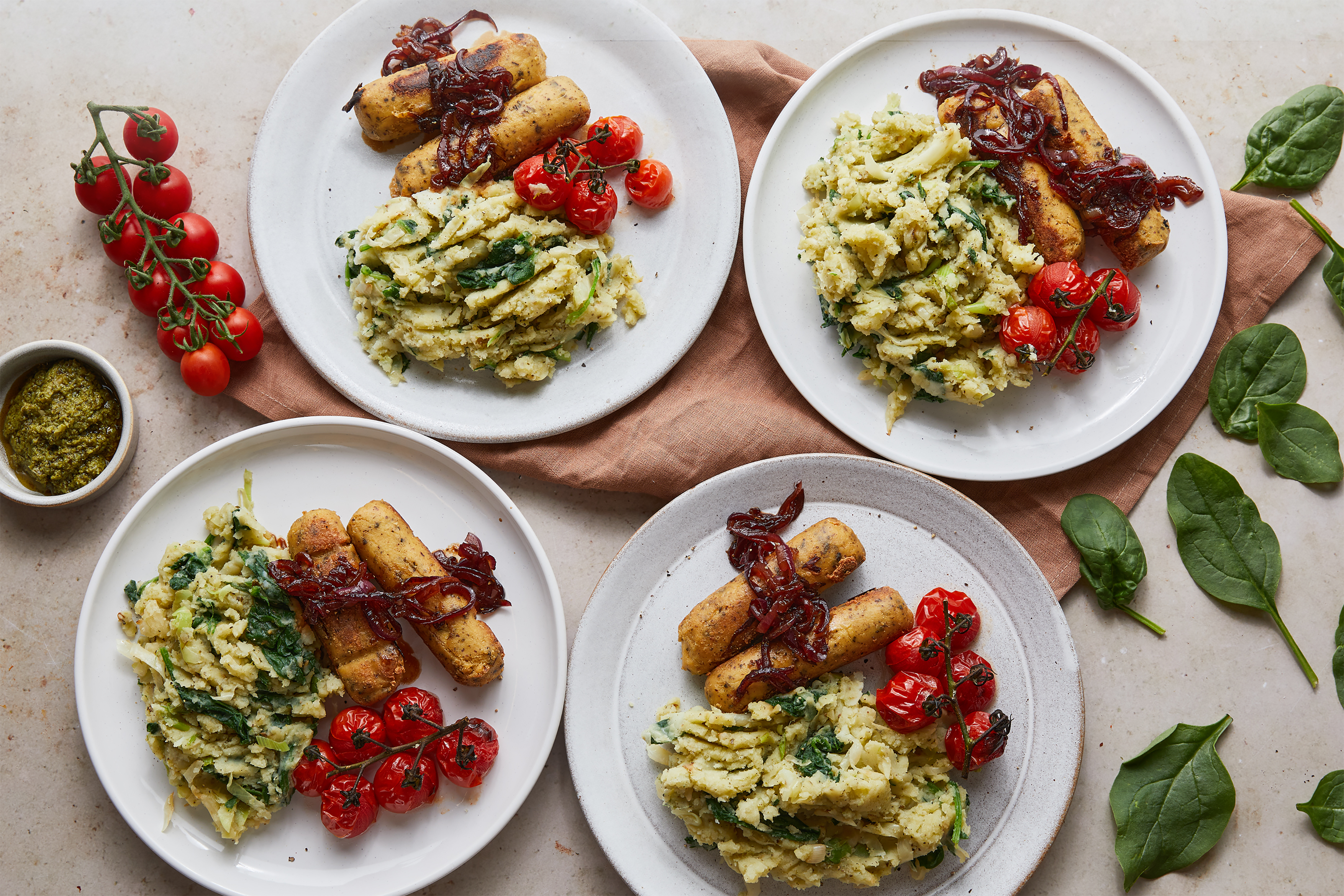 Vegan sausages, pesto colcannon & roast tomatoes