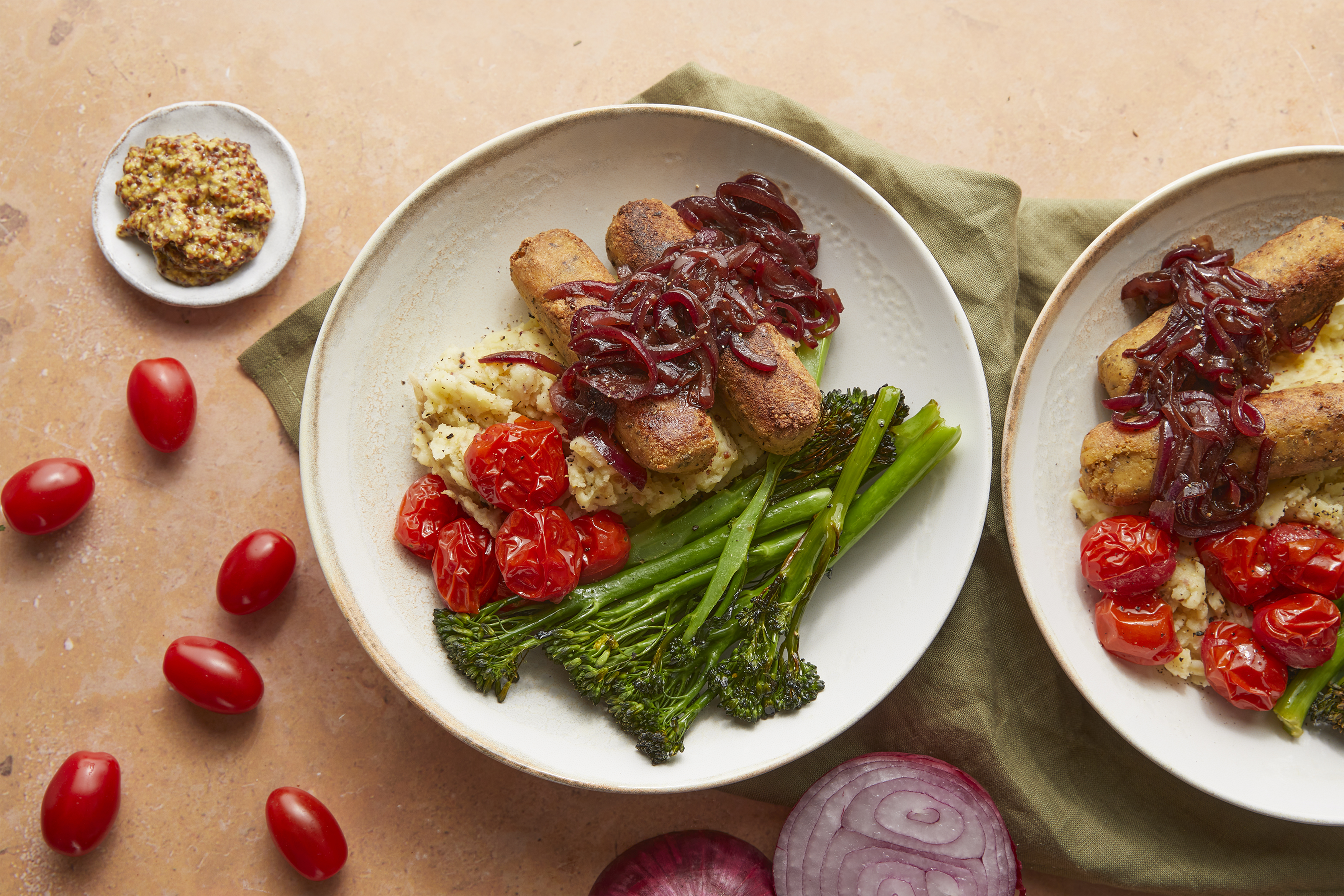 Veggie sausages, roast tomatoes & balsamic onions