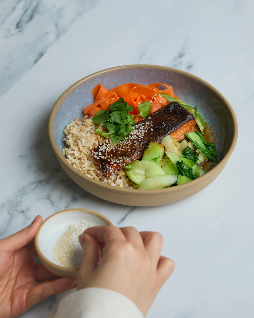 Succulent responsibly-sourced salmon fillets are baked in a sweet and savoury teriyaki sauce, creating perfectly tender fish and a sticky, caramelised topping. Serve atop nutty brown rice, leafy pak choi, and a vibrant side of tangy pickled carrots.